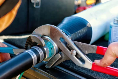 Technician tightening an industrial pipe connection in Bullhead City