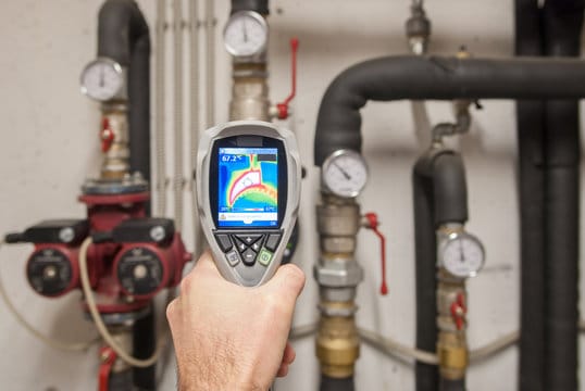 Plumber using a thermal imaging camera to inspect pipes in Bullhead City