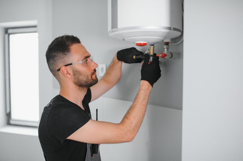 Technician performing water heater maintenance in Bullhead City