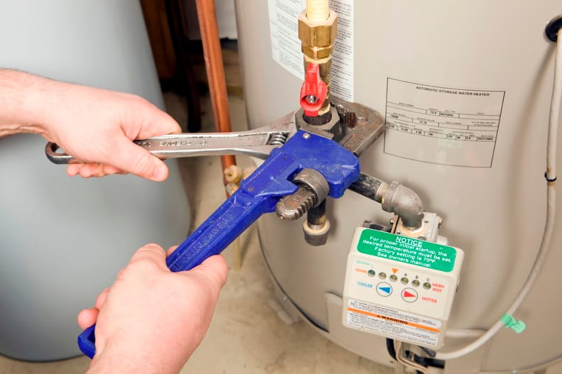 Plumber repairing a water heater valve in Bullhead City
